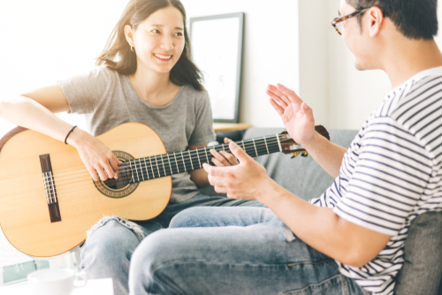 person playing guitar during a therapy session